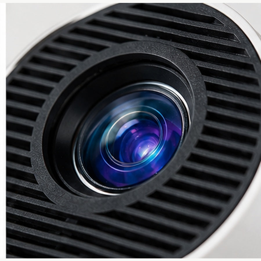 Close-up of the portable projector's blue-purple lens within its black vented grille. — ULTAVEX &amp; CO