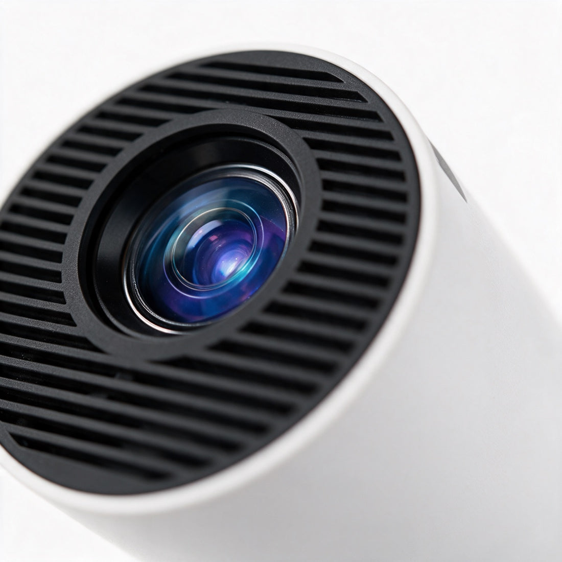 Close-up of the projector's black vented front grille and blue-purple lens. — ULTAVEX &amp; CO